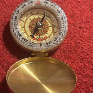 Brass Compass with Red and Gold Details.